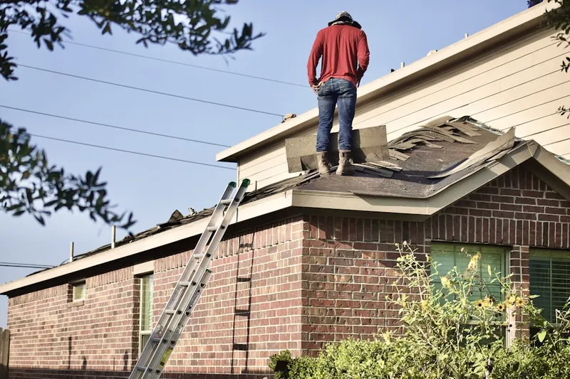 Professional roofer working on a residential roof in Wassergass